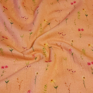 100% Cotton Double Gauze Muslin Fabric with Dainty Floral prints on Peach Gauze. Nice Quality soft European Fabric. Sold by the 1/2 yard.