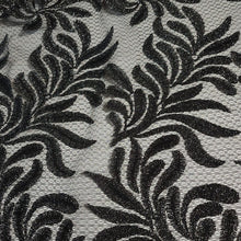 Load image into Gallery viewer, Beautiful Black Glittery Lace leaves on Gray Fishnet Lace, Unique and Trendy Lace, Ideal for Apparel and Home Decor. Sold by the 1/2 yard.
