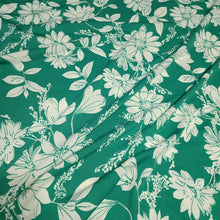 Load image into Gallery viewer, Poly Spandex Knit White Floral on Green, Nice and Flowy Drape, Perfect for Sewing Apparel, 2 Way Stretch Knit Fabric, Sold By The 1/2 Yard
