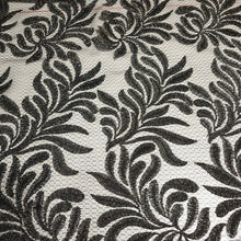 Load image into Gallery viewer, Beautiful Black Glittery Lace leaves on Gray Fishnet Lace, Unique and Trendy Lace, Ideal for Apparel and Home Decor. Sold by the 1/2 yard.
