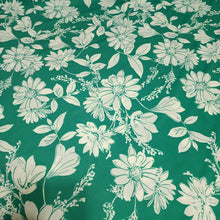 Load image into Gallery viewer, Poly Spandex Knit White Floral on Green, Nice and Flowy Drape, Perfect for Sewing Apparel, 2 Way Stretch Knit Fabric, Sold By The 1/2 Yard
