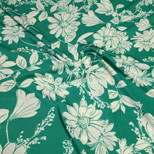 Load image into Gallery viewer, Poly Spandex Knit White Floral on Green, Nice and Flowy Drape, Perfect for Sewing Apparel, 2 Way Stretch Knit Fabric, Sold By The 1/2 Yard
