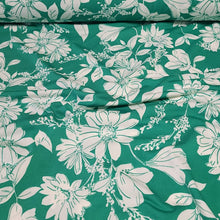 Load image into Gallery viewer, Poly Spandex Knit White Floral on Green, Nice and Flowy Drape, Perfect for Sewing Apparel, 2 Way Stretch Knit Fabric, Sold By The 1/2 Yard
