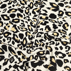 SWIM Fabric: Nylon Spandex Knit, Fun Black, Beige, and White Cheetah Print. Very Nice Quality Activewear and Swimwear. Sold by the 1/2 yard