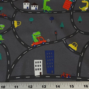 European Knit Fabric, Dinosaurs in the City in Trucks and Cars, 4-way stretch Cotton Spandex jersey knit, Sold by the 1/2 yard.