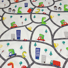 Load image into Gallery viewer, European Knit Fabric, Dinosaurs in the City in Trucks and Cars, 4-way stretch Cotton Spandex jersey knit, Sold by the 1/2 yard.
