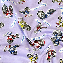 Load image into Gallery viewer, Cotton Jersey T-Shirt Knit, Bike Fabric with Bicycles and Tricycle on Lavendar Background. 2-way stretch. Sold by the 1/2 yard
