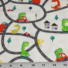 Load image into Gallery viewer, European Knit Fabric, Dinosaurs in the City in Trucks and Cars, 4-way stretch Cotton Spandex jersey knit, Sold by the 1/2 yard.
