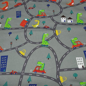 European Knit Fabric, Dinosaurs in the City in Trucks and Cars, 4-way stretch Cotton Spandex jersey knit, Sold by the 1/2 yard.