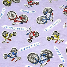 Load image into Gallery viewer, Cotton Jersey T-Shirt Knit, Bike Fabric with Bicycles and Tricycle on Lavendar Background. 2-way stretch. Sold by the 1/2 yard
